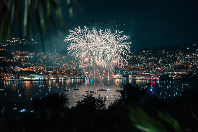 lake, nature, port, fireworks, sparkles, celebration, sunset, mountains, sky, outdoors, travel, landscape, night, night sky, dark, city. How to build an event marketing budget before briefing an agency