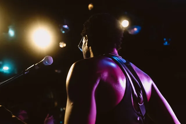 concert, spotlight, musician, lifestyle, stage, electric guitar, black sunglasses, microphone, rock music, heat, crowd, dark skin tone, concert hall, orange lighting, beer, entertainment, muscles, performance, artist. Build an event marketing strategy framework that earns sign-off