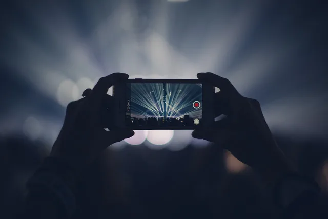 iphone, concert, lights, stage lights, record, video, recording, video recording, capture, apple product, hands, audience, event, live event, live performance, dark, party, smartphone, crowd, video, video, video, video, video. Winning event marketing agency work in Leeds and Newcastle